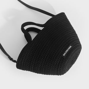 Flat shot of Balenciaga Ibiza nylon and leather basket bag in black