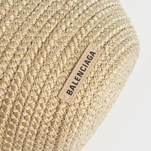 Logo shot of Balenciaga Ibiza nylon and leather basket bag in beige