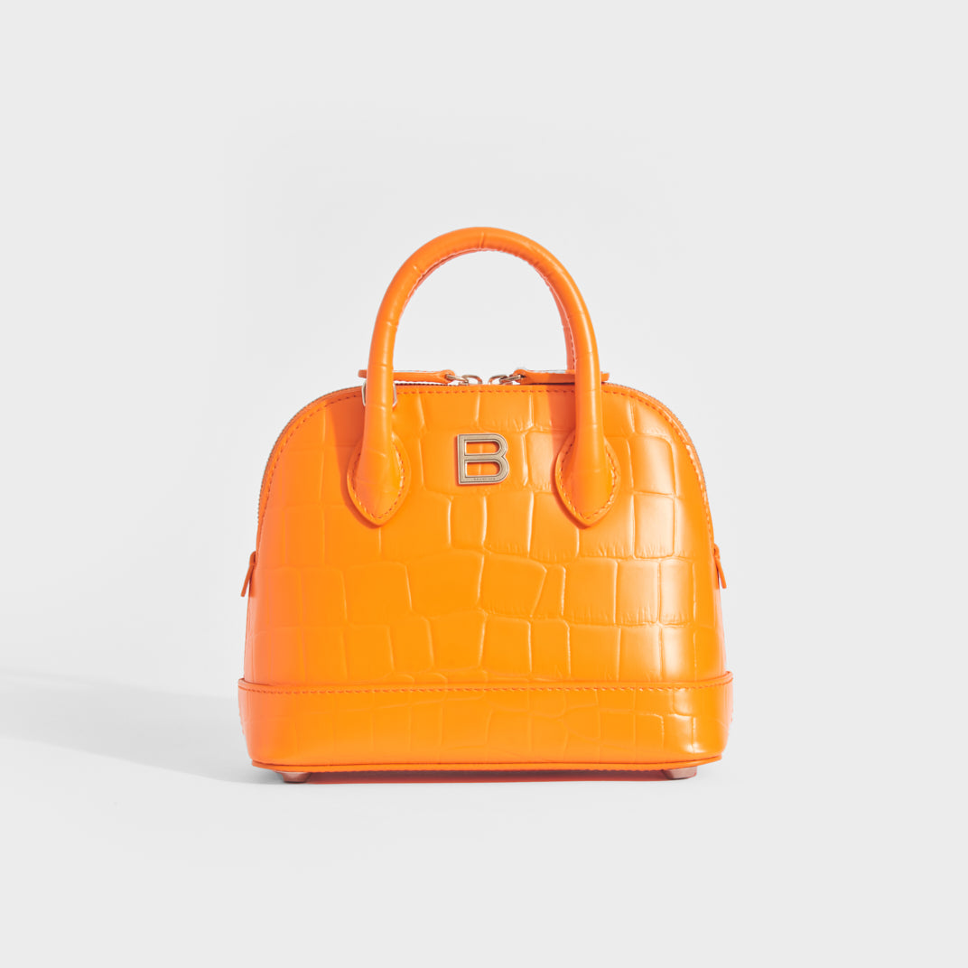Front view of Balenciaga XXS Ville Embossed leather tote in orange