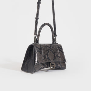 Side of the BALENCIAGA Small Hourglass Top Handle Snakeskin-Effect Leather Bag in Dark Grey and Black