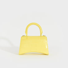 Load image into Gallery viewer, Rear view of the BALENCIAGA XS Hourglass Top Handle Bag in Light Yellow Embossed Croc