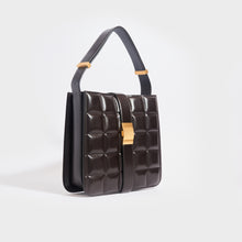 Load image into Gallery viewer, Side view of the BOTTEGA VENETA The Padded Marie Leather Shoulder Bag in Fondente