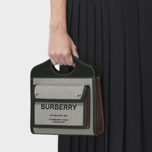 Load image into Gallery viewer, Model holding the BURBERRY Mini Tri-Colour Canvas &amp; Leather Pocket Bag in Grey