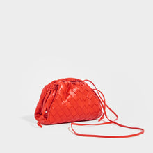 Load image into Gallery viewer, Side view of the BOTTEGA VENETA The Pouch 20 Intrecciato Crossbody in Bright Red