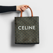 Load image into Gallery viewer, Model holding the CELINE Small Triomphe Cabas Vertical in Canvas and Calfskin Leather