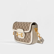 Load image into Gallery viewer, Side view of the GUCCI 1955 Horsebit Mini Bag in GG Supreme Canvas with White Leather