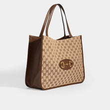 Load image into Gallery viewer, Side view of the GUCCI 1955 Horsebit Tote Bag in Brown GG Supreme Canvas