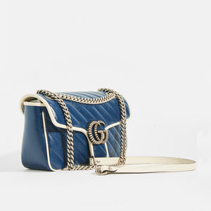 Side view of Gucci GG Marmont Small Shoulder Bag in Navy Matelasse Leather with White trim and silver chain strap