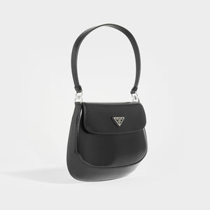 Side view of the Products PRADA Cleo Brushed Leather Shoulder Bag With Flap in Black