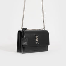 Load image into Gallery viewer, Side view of the SAINT LAURENT Sunset Medium Leather Shoulder Bag in Black