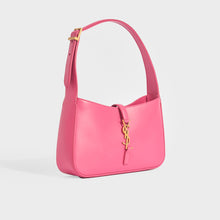 Load image into Gallery viewer, Side view of Saint Laurent Le 5 a 7 small leather handbag in bubblegum pink with gold hardware