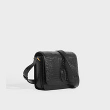 Load image into Gallery viewer, Side view of the SAINT LAURENT Le 61 Framed Small Saddle Bag in Mock-Croc Leather in Black