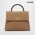 Coco Caviar Top Handle Bag in Beige