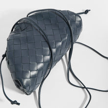Load image into Gallery viewer, Top view of BOTTEGA VENETA Pouch 20 Intrecciato Crossbody in Deep blue Leather