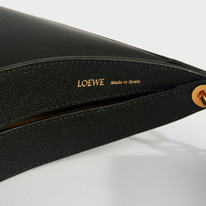 Loewe, made in Spain gold leaf embossing on Loewe Luna leather shoulder bag in black.