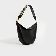 Load image into Gallery viewer, Angled view of Loewe Luna shoulder bag in black leather with logo canvas strap