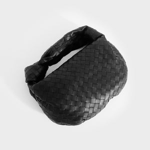 Flat shot of Bottega Veneta Jodie Intrecciato knotted leather shoulder bag in black