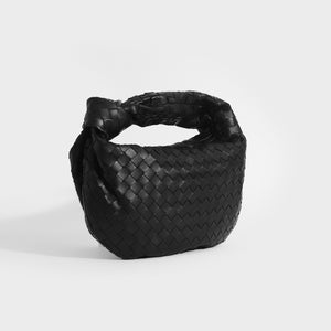 Side view of Bottega Veneta Jodie intrecciato black leather and knotted shoulder strap bag.