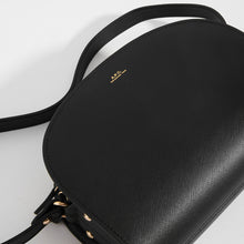 Load image into Gallery viewer, Top detail of APC Half Moon Saffiano Leather Crossbody in Black with logo detail and strap 