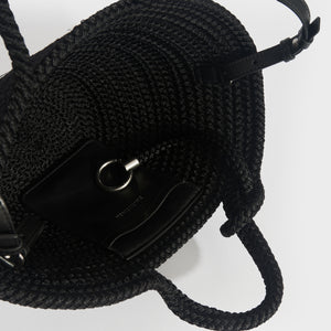 Inside shot of Balenciaga Ibiza nylon and leather basket bag in black.
