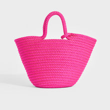 Load image into Gallery viewer, Back view of Balenciaga Ibiza nylon and leather basket bag in pink
