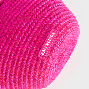 View of logo on Balenciaga Ibiza nylon and leather basket bag in pink