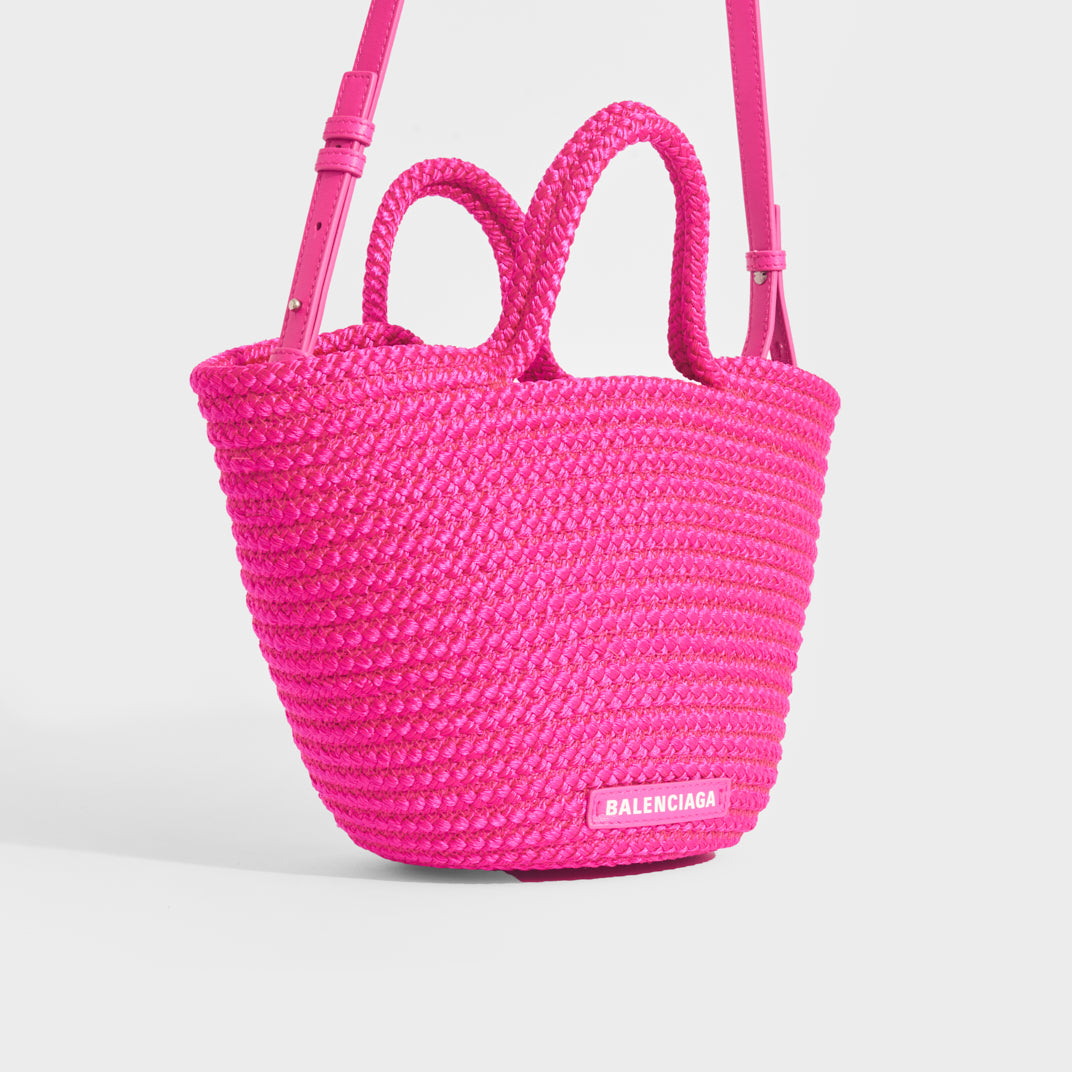 Side view of Balenciaga Ibiza nylon and leather basket bag in pink
