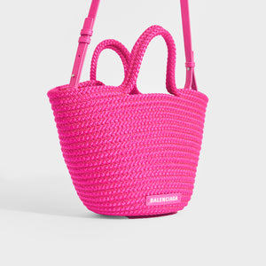 Side view of Balenciaga Ibiza nylon and leather basket bag in pink