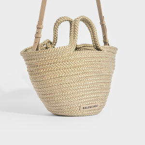 Side view of Balenciaga Ibiza nylon and leather basket bag in beige