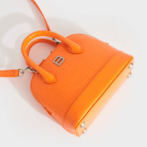 Flat shot of Balenciaga XXS Ville embossed leather tote in Orange