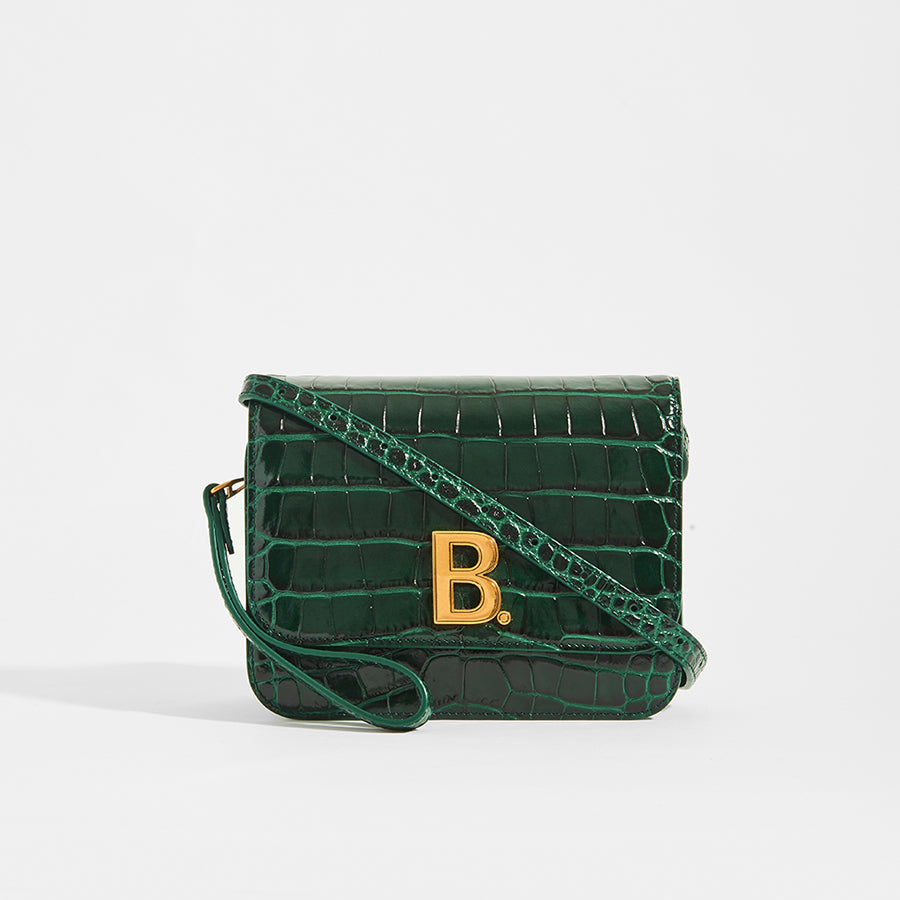Dark Green BALENCIAGA B Small Bag in Croc-Embossed Calfskin with cross body strap and gold Balenciaga B logo on the front