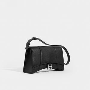 Side view of the BALENCIAGA Hourglass Baguette Grained Leather Shoulder Bag