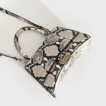 Load image into Gallery viewer, Top down view of the BALENCIAGA Small Hourglass Top Handle Bag in Python Print