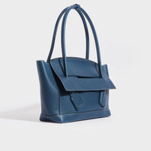 Load image into Gallery viewer, Side view of the BOTTEGA VENETA Arco Large Leather Tote Bag in Deep Blue