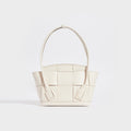 Rear view of the BOTTEGA VENETA Arco Small Intrecciato Leather Tote Bag in White