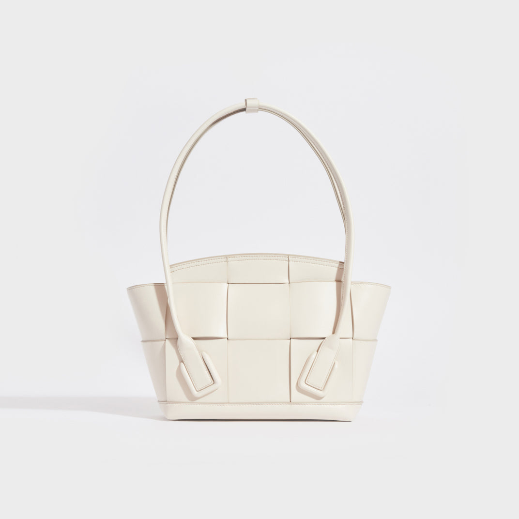 Rear view of the BOTTEGA VENETA Arco Small Intrecciato Leather Tote Bag in White