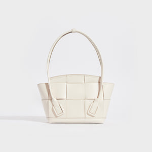 Rear view of the BOTTEGA VENETA Arco Small Intrecciato Leather Tote Bag in White