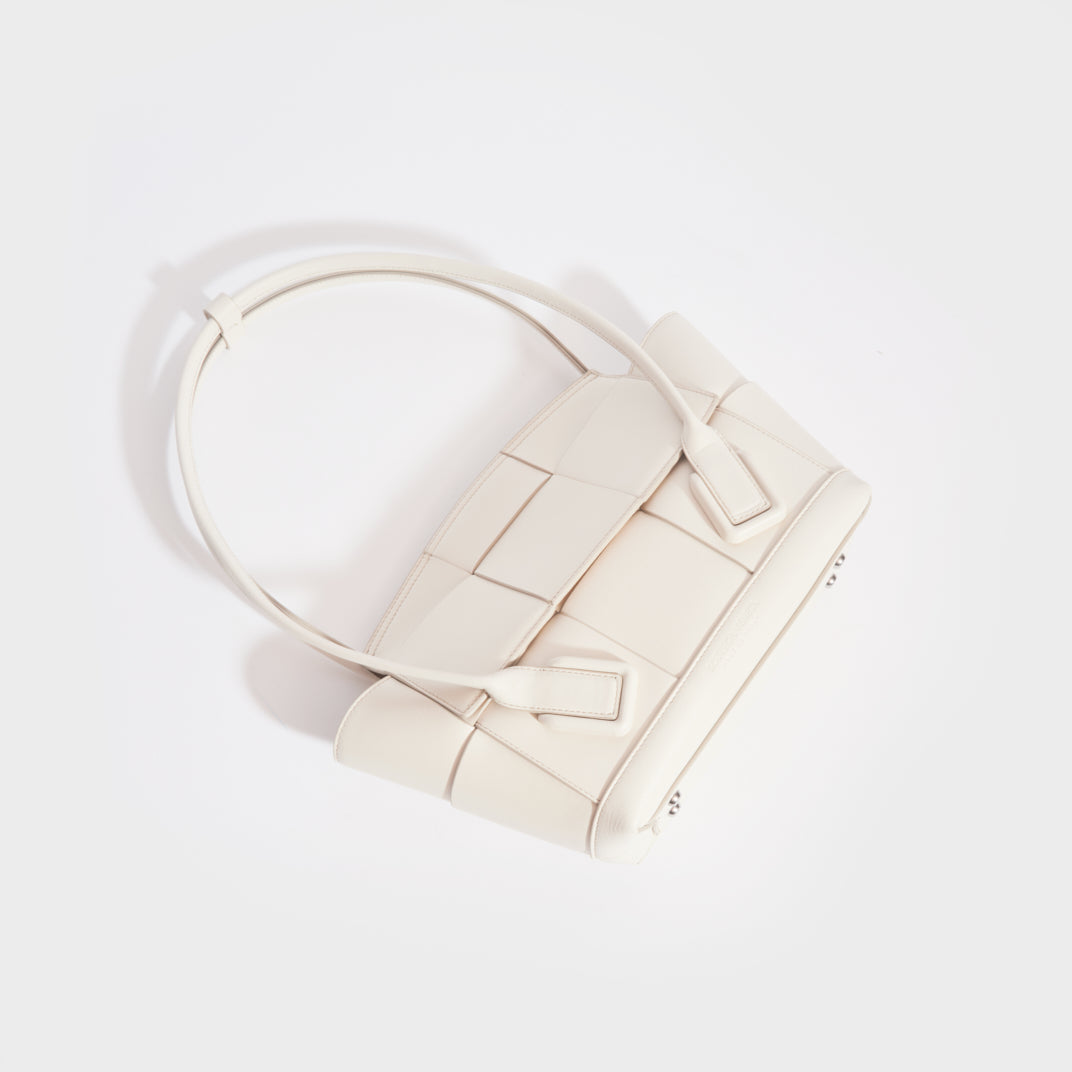 Top down view of the BOTTEGA VENETA Arco Small Intrecciato Leather Tote Bag in White
