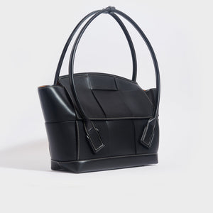 Side view of the BOTTEGA VENETA Arco Large Intrecciato Leather Tote Bag in Black [ReSale]