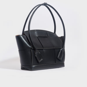 Side view of the BOTTEGA VENETA Arco Large Intreccio Leather Tote Bag in Black