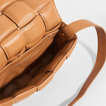 Load image into Gallery viewer, Inside view of BOTTEGA VENETA Padded Cassette Crossbody Bag in Caramel Lambskin Leather
