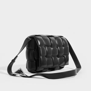 Side view of the Front view of the BOTTEGA VENETA Padded Cassette Bag in Black (Nero) with Silver Hardware