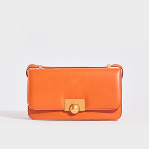 Front view of the BOTTEGA VENETA The Classic Small Leather Shoulder Bag in Orange