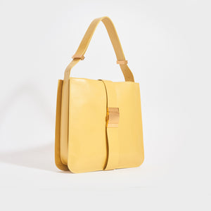 Side view of the BOTTEGA VENETA The Marie Shoulder Bag in Yellow