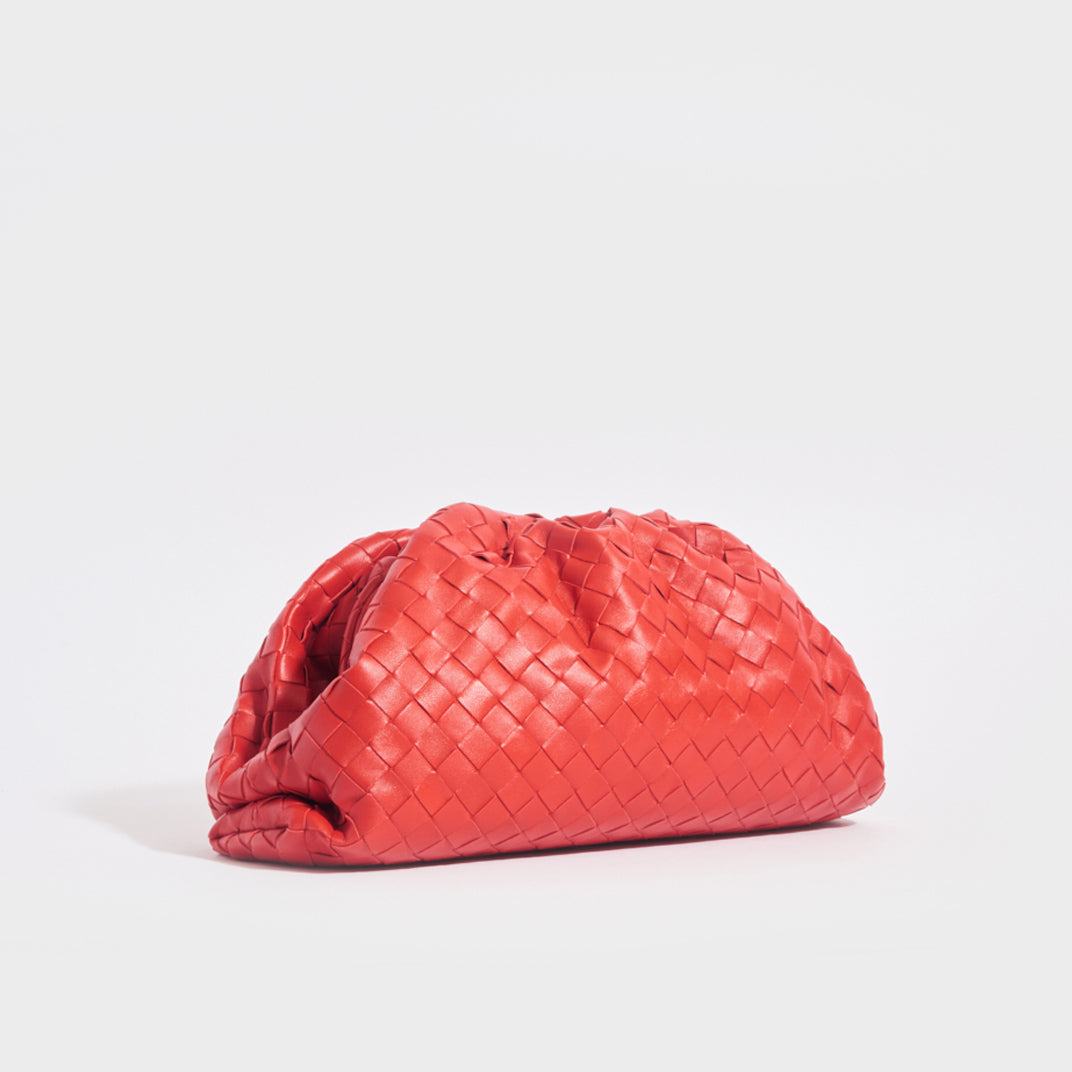 Side view of the BOTTEGA VENETA The Pouch Intrecciato Leather Clutch in Red