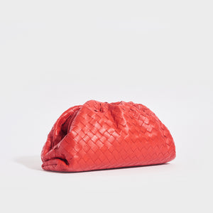 Side view of the BOTTEGA VENETA The Pouch Intrecciato Leather Clutch in Red