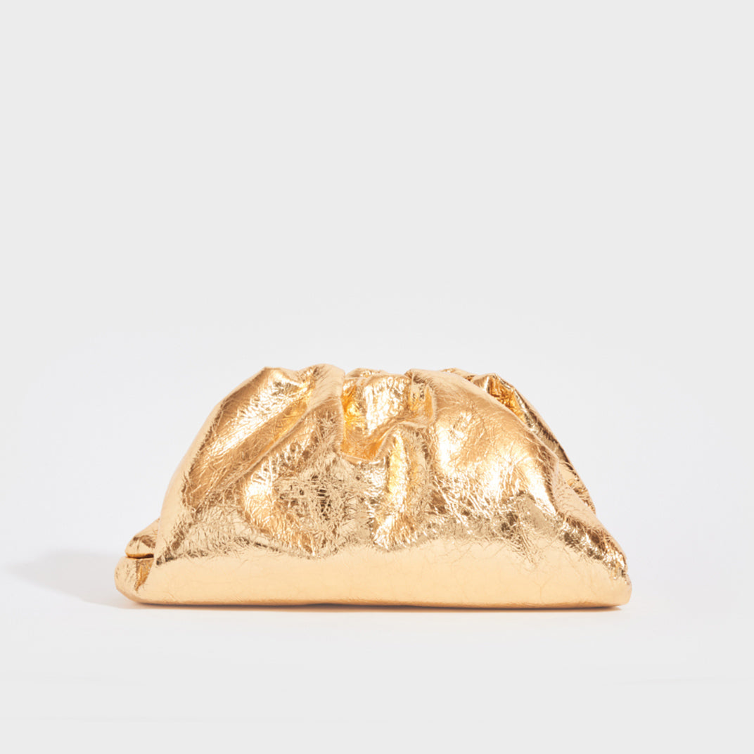 Front view of the BOTTEGA VENETA The Pouch Leather Clutch in Gold