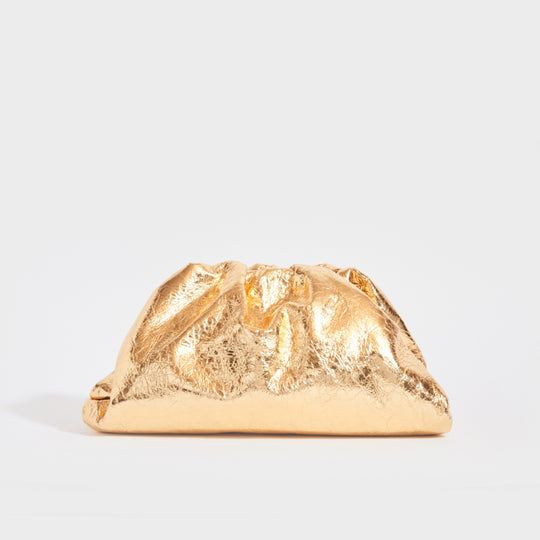 Front view of the BOTTEGA VENETA The Pouch Leather Clutch in Gold