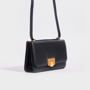 Side view of the BOTTEGA VENETA The Classic Small Leather Shoulder Bag in Black