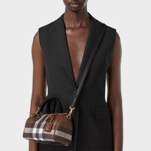 Load image into Gallery viewer, Model wearing the BURBERRY Check and Leather Mini Bowling Bag in Dark Birch Brown